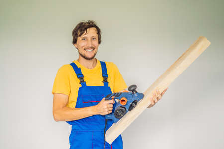 Carpenter with grinder and plane. Woodworking, professionalの写真素材