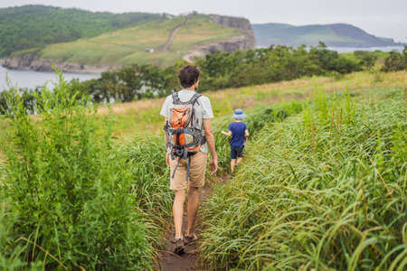 Male tourist on the background of beautiful rocks and the sea. Hiking concept. Tobizin cape. Vladivostok, island Russky. Sea of Japan. Primorye. Primorsky krai. Nature of Russia. Tourism and travel in Russia.の写真素材
