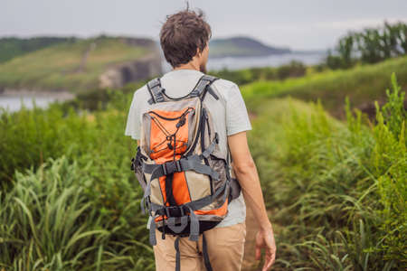 Male tourist on the background of beautiful rocks and the sea. Hiking concept. Tobizin cape....