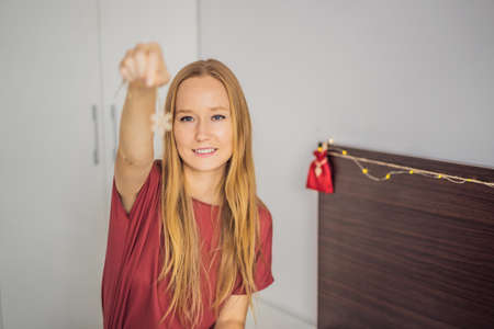 Woman making Christmas advent calendar. Pouches on a ropeの写真素材