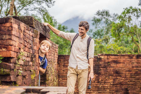 Dad and son tourists in Temple ruin of the My Son complex, Vietnam. Vietnam opens to tourists again...