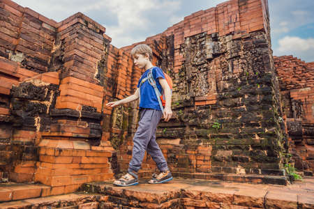 Boy tourist in Temple ruin of the My Son complex, Vietnam. Vietnam opens to tourists again after quarantine Coronovirus COVID 19の写真素材