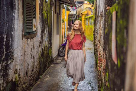 Woman tourist on background of Hoi An ancient town, Vietnam.の写真素材