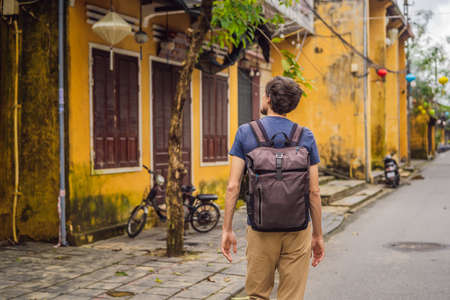 Man tourist on background of Hoi An ancient town, Vietnam.