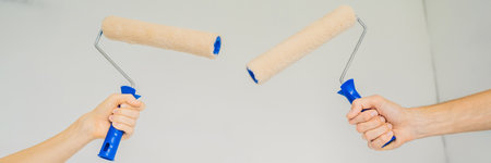 renovation diy paint couple in new home painting wall BANNER, LONG FORMATの写真素材