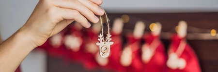 Woman making Christmas advent calendar. Pouches on a rope BANNER, LONG FORMATの写真素材