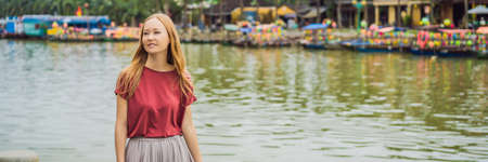 Woman tourist on background of Hoi An ancient town, Vietnam. Vietnam opens to touristsの写真素材