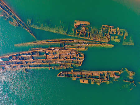Abandoned broken shipwreck sticking out of the sea
