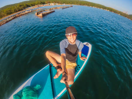 Attractive Man on Stand Up Paddle Board, SUP