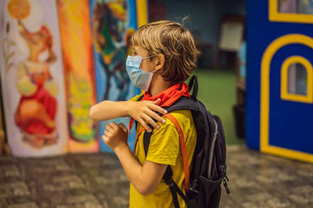 Schoolboy with protect mask on face. Face mask for protection virus outbreak.