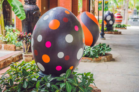 Multicolored eggs in the grass. Easter eggs hunt, outdoors. Celebrating Easter holidayの写真素材