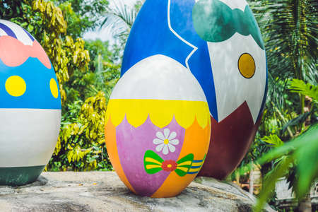 Multicolored eggs in the grass. Easter eggs hunt, outdoors. Celebrating Easter holidayの写真素材
