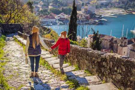Mom and son travelers in Montenegro in Kotor Old Town Ladder of Kotor Fortress Hiking Trail. Aerial drone view.の写真素材