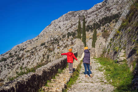 Mom and son travelers in Montenegro in Kotor Old Town Ladder of Kotor Fortress Hiking Trail. Aerial drone viewの写真素材