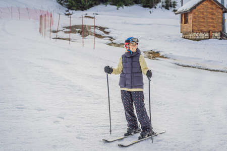 Woman learning to ski. Young woman skiing on a snowy road in the mountainsの写真素材