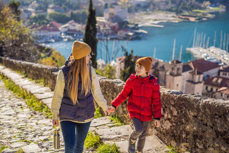 Mom and son travelers in Montenegro in Kotor Old Town Ladder of Kotor Fortress Hiking Trail. Aerial drone viewの写真素材