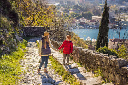 Mom and son travelers in Montenegro in Kotor Old Town Ladder of Kotor Fortress Hiking Trail. Aerial...