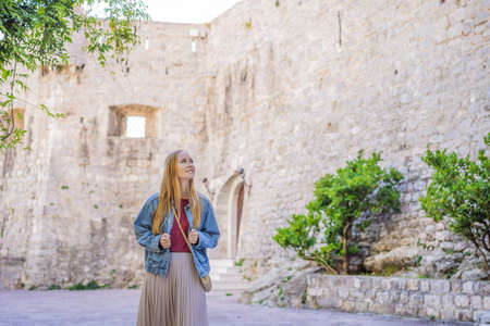Young woman tourist in the old town of Budva. Travel to Montenegro conceptの写真素材