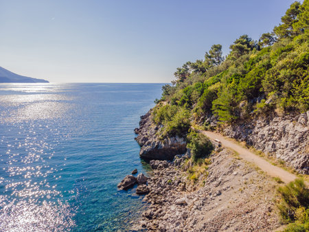 Picturesque sea Adriatic coast of Montenegro. Turquoise Mediteran sea and rocky shore with evergreen coniferous trees. Wonderful summer landscape. Droneの写真素材