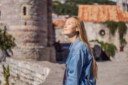 Young woman tourist in the old town of Budva. Travel to Montenegro conceptの写真素材