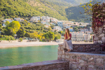 Woman tourist on background of beautiful view of the island of St. Stephen, Sveti Stefan on the Budva Riviera, Budva, Montenegro. Travel to Montenegro conceptの写真素材