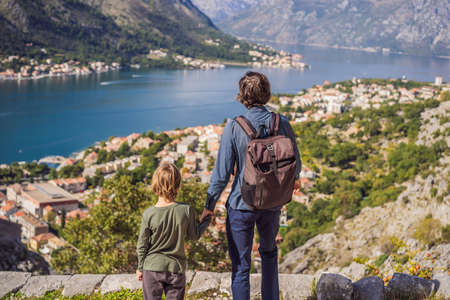 Dad and son travellers enjoys the view of Kotor. Montenegro. Bay of Kotor, Gulf of Kotor, Boka...