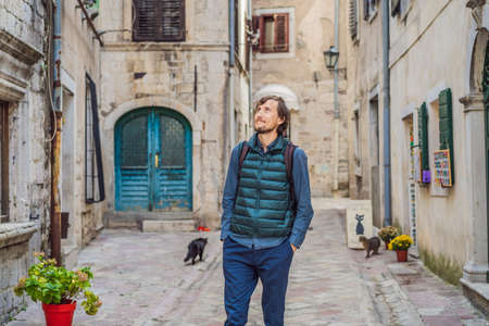 Man tourist enjoying Colorful street in Old town of Kotor on a sunny day, Montenegro. Travel to Montenegro conceptの写真素材