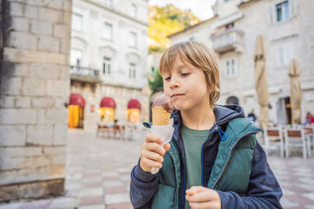 Boy tourist enjoying Colorful street in Old town of Kotor on a sunny day, Montenegro. Travel to Montenegro conceptの写真素材
