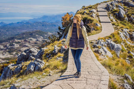 Woman traveller in mountain landscape at national park Lovcen, Montenegro. Travel to Montenegro conceptの写真素材