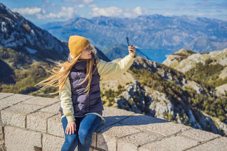 Woman traveller in mountain landscape at national park Lovcen, Montenegro. Travel to Montenegro conceptの写真素材