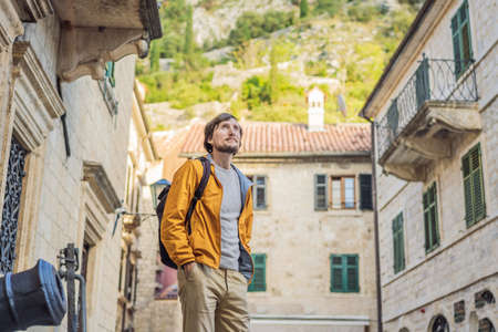 Man tourist enjoying Colorful street in Old town of Kotor on a sunny day, Montenegro. Travel to Montenegro conceptの素材 [FY310184805700]