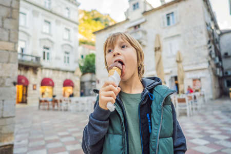 Boy tourist enjoying Colorful street in Old town of Kotor on a sunny day, Montenegro. Travel to Montenegro conceptの写真素材