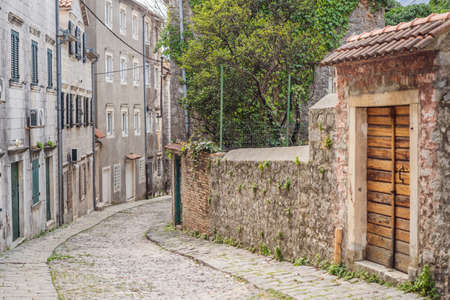 Scenic panorama view of the historic town of Risan at famous Bay of Kotor on a beautiful sunny day with blue sky and clouds in summer, Montenegro, southern Europeの写真素材