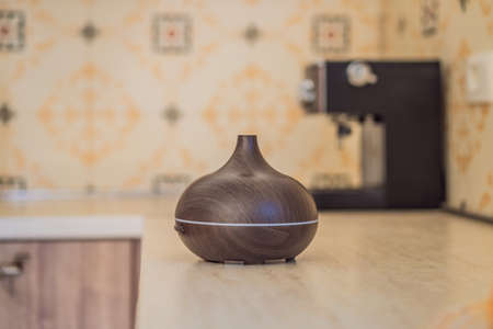 Aroma oil diffuser on table in kitchen
