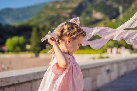 Emotional little girl in a pink dressの写真素材