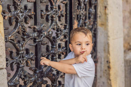Adorable caucasian kid asking to be quiet with finger on lips. silence and secret conceptの写真素材