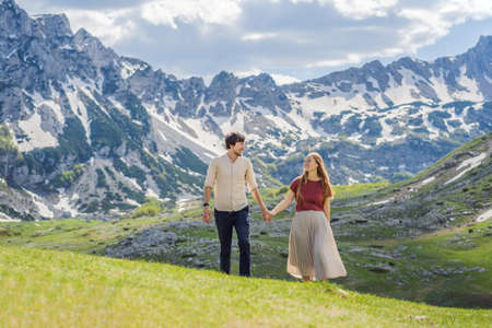 Couple tourists man and woman in Mountain lake landscape on Durmitor mountain in Montenegro...