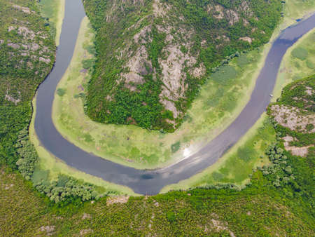 Canyon of Rijeka Crnojevica river near the Skadar lake coast. One of the most famous views of Montenegro. River makes a turn between the mountains and flows backwardの写真素材