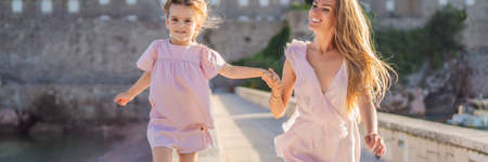 BANNER, LONG FORMAT Mother and daughter tourists on background of beautiful view St. Stephen islandの写真素材
