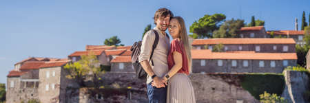 BANNER, LONG FORMAT Man and woman tourists on background of beautiful view of the island of St....