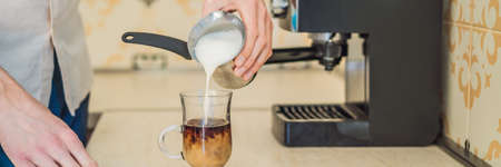 Handsome man using coffee machine in kitchen BANNER, LONG FORMATの写真素材