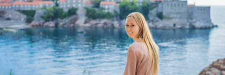 BANNER, LONG FORMAT Woman tourist on background of beautiful view of the island of St. Stephen,...