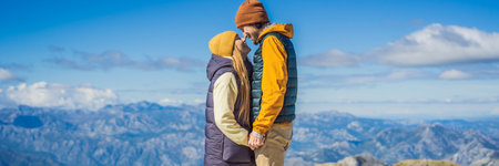BANNER, LONG FORMAT Couple man and woman tourists in mountain landscape at national park Lovcen, Montenegro. Travel to Montenegro conceptの写真素材
