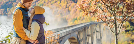 BANNER, LONG FORMAT Montenegro. Happy couple man and woman in background of Dzhurdzhevich Bridge...