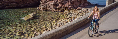 Woman tourist on a bicycle explores Budva in Montenegro. Cycling in Montenegro concept BANNER, LONG...