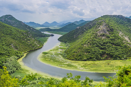 Canyon of Rijeka Crnojevica river near the Skadar lake coast. One of the most famous views of Montenegro. River makes a turn between the mountains and flows backward.の写真素材