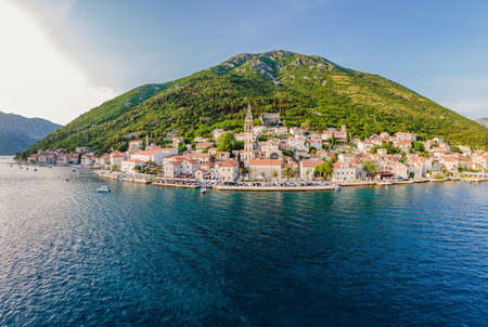 Scenic panorama view of the historic town of Perast at famous Bay of Kotor with blooming flowers on...