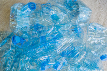 Large stack of old plastic bottles on the floorの写真素材