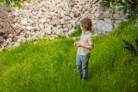 Boy tourist walks through the old town of Bar in Montenegro. Happy tourist walks in the mountains. Suburbs of the city of Bar, Montenegro, Balkans. Beautiful nature and landscapeの写真素材