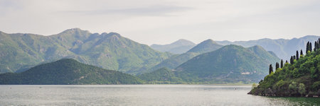 BANNER, LONG FORMAT National Park Skadar Lake. Montenegro. Skadar lake. Dawn. View from above. The largest lake in the Balkans. Mountains of the Dinaric Highlands. Swampy shores and colorful vegetation of Skadar Lake.の写真素材